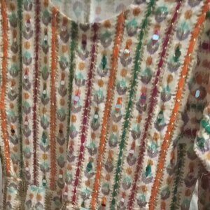 A handmade cotton Buti block print peplum dress with mirror work